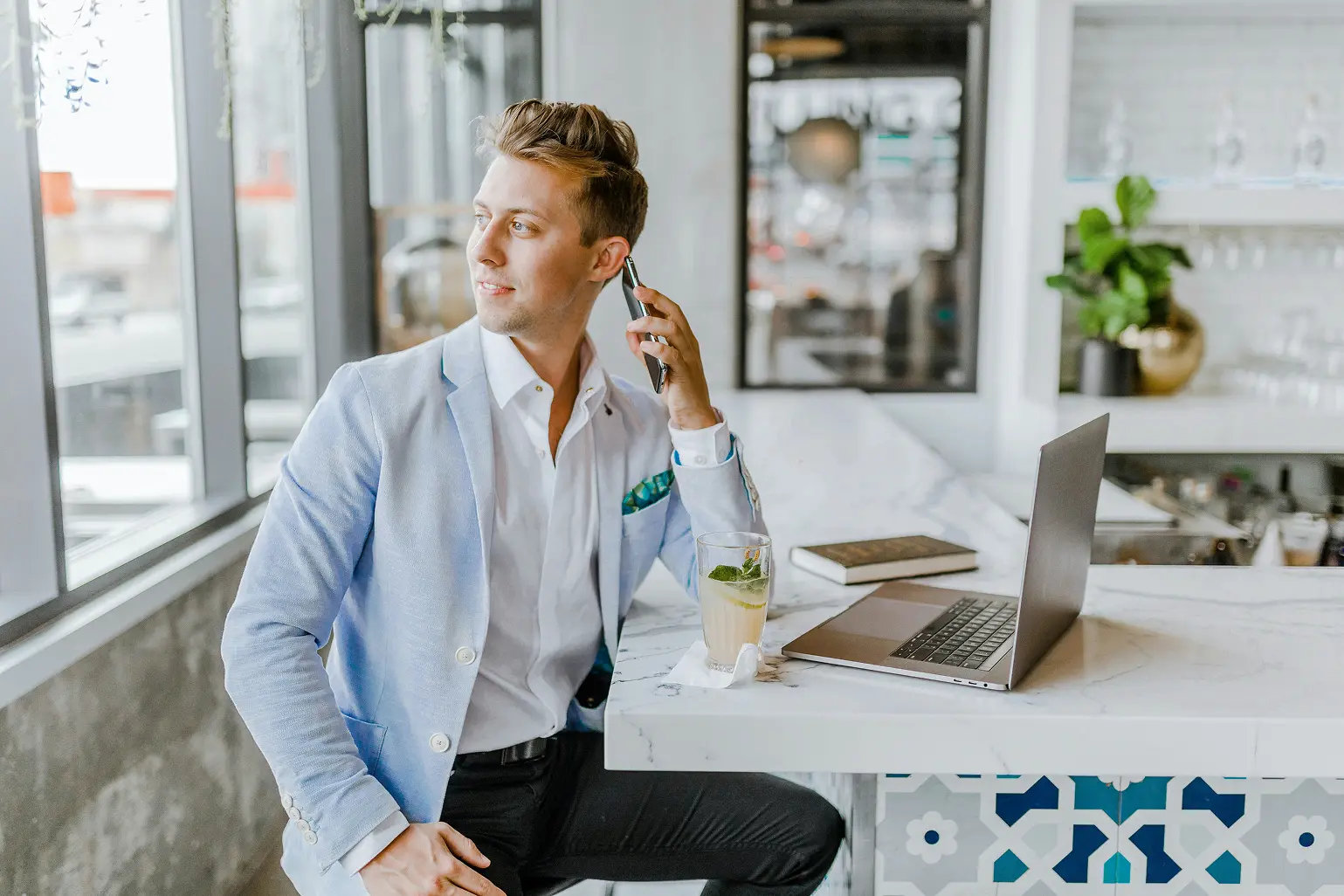 Professional reviewing AI implementation plans on phone and laptop